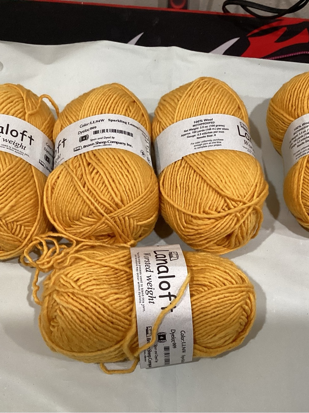 5 skeins of brown sheep co lanaloft worsted weight yarn in sparkling lemon color